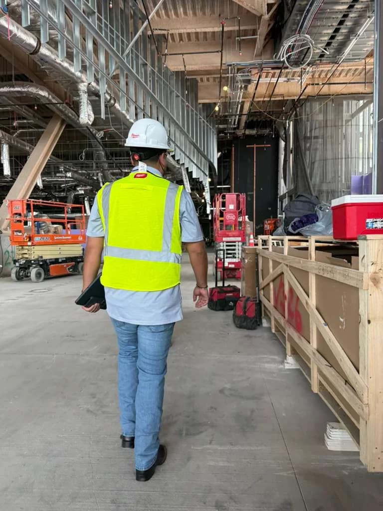 Site superintendent reviewing progress on a construction site at sunset